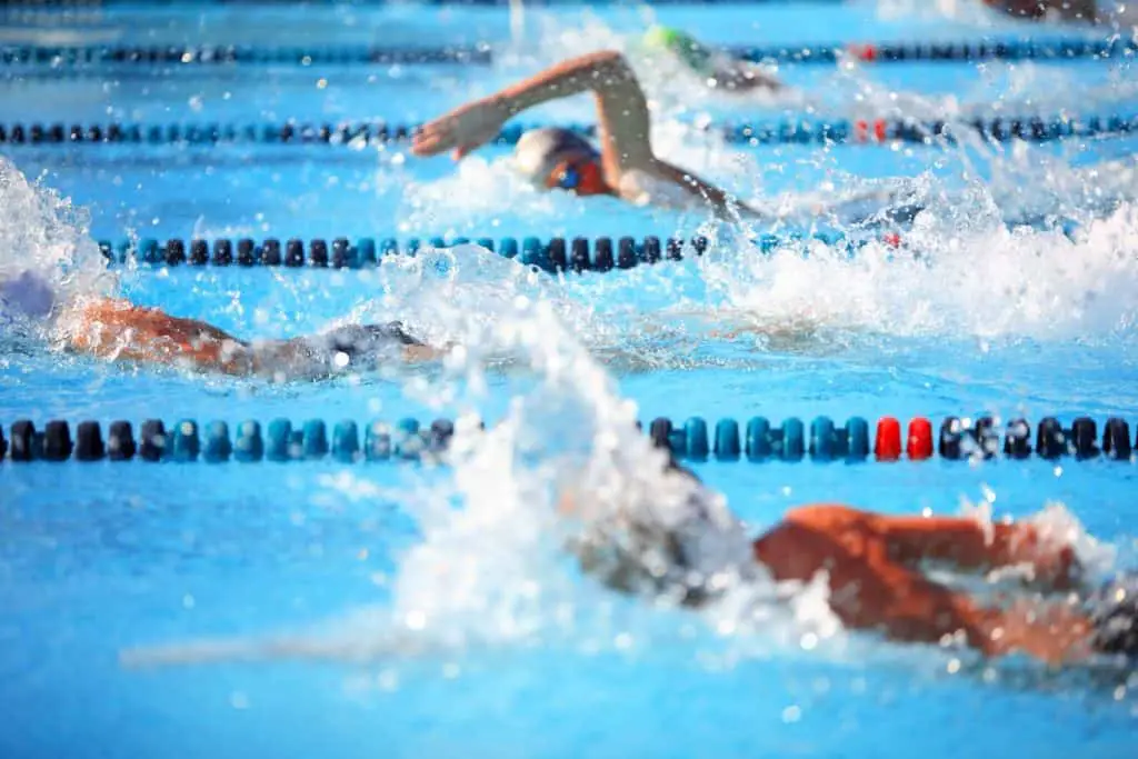 Swimmers in a freestyle race - How Long Do You Need to Swim to Get a Good Workout