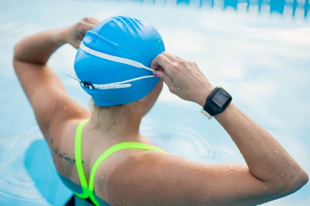 Girl swimming in the pool with her Swimmo watch on to track results - Swimmo Watch Review
