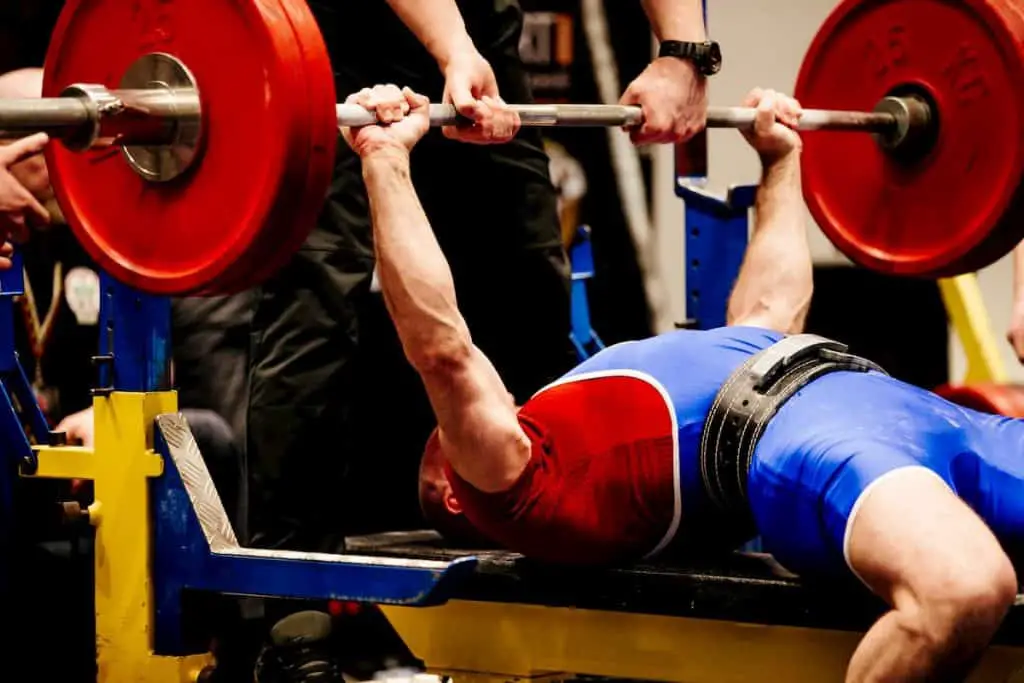 Male powerlifter bench press in powerlifting competition - What Does PR Mean in Lifting